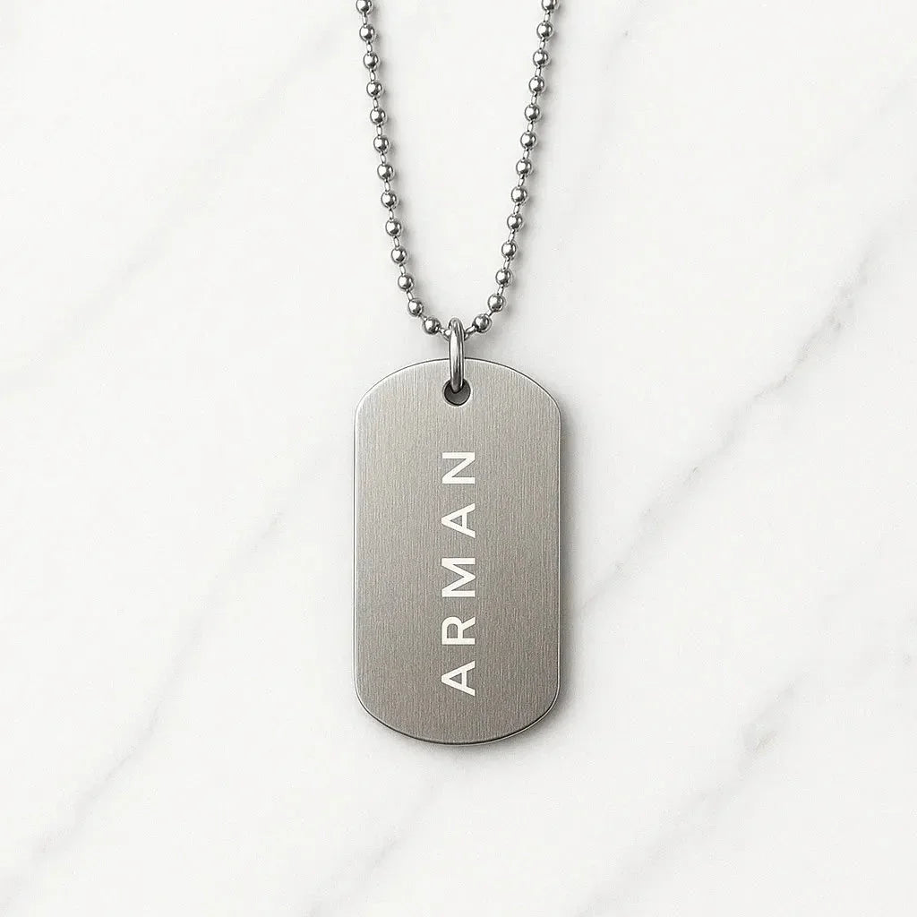 Silver necklace with a tag engraved with 'ARMAN' on a white background