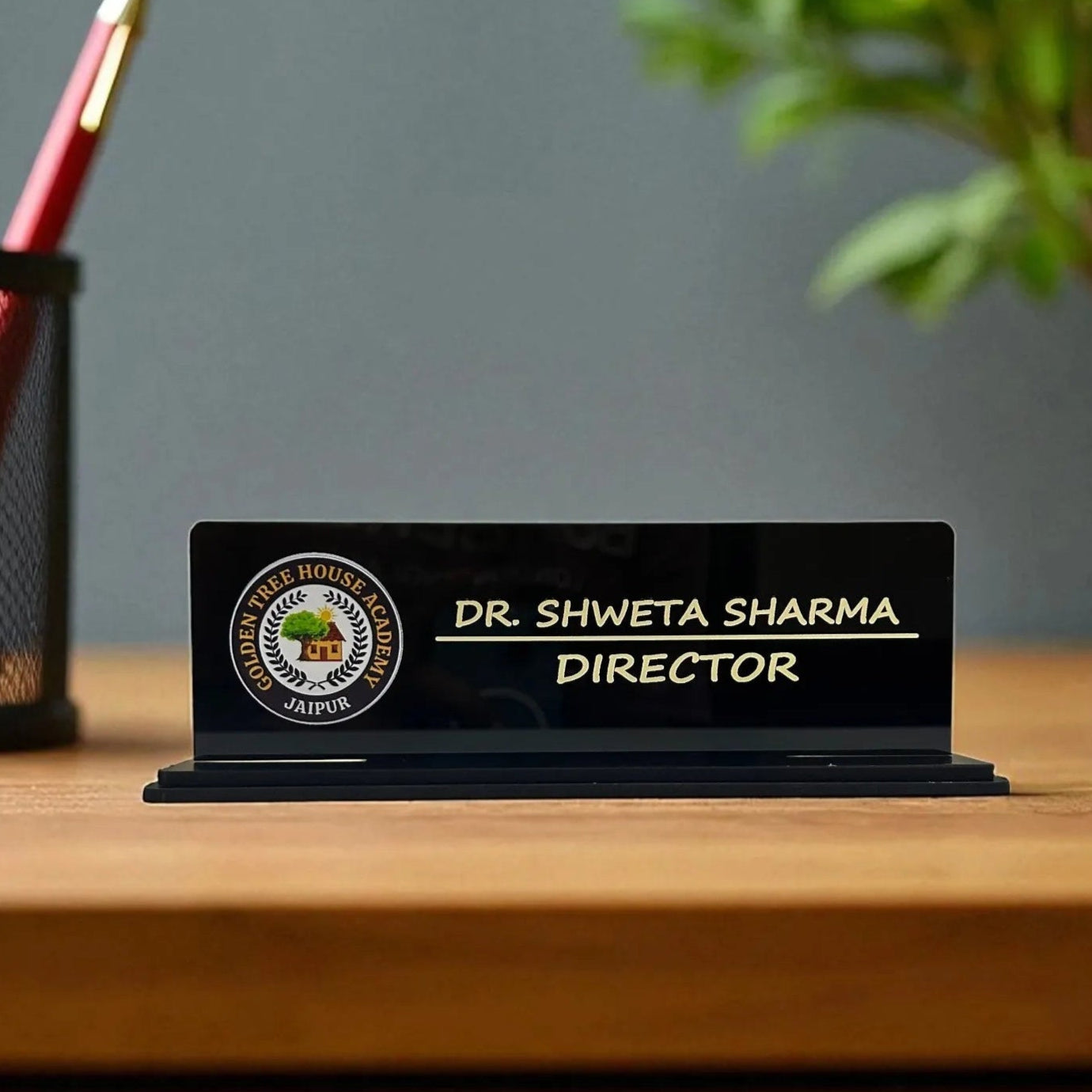 Personalized desk nameplate with a logo on a wooden surface