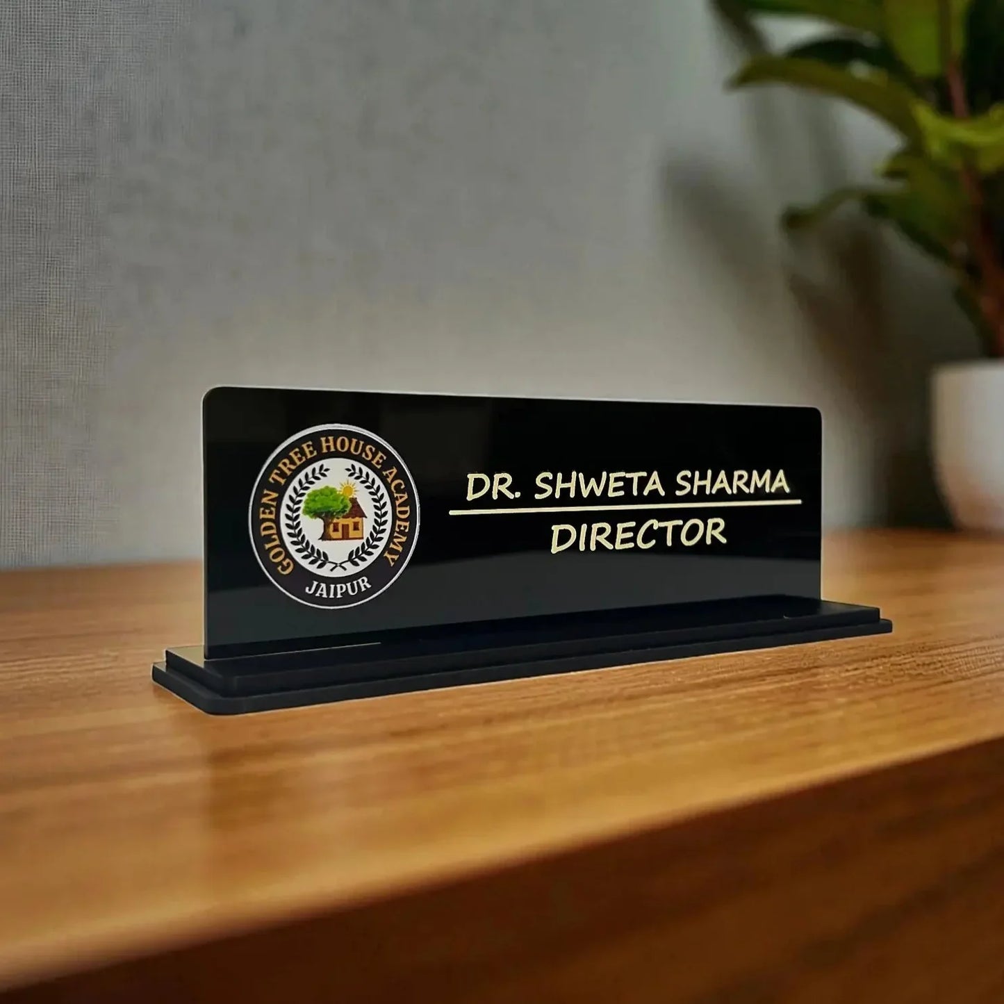 Personalized desk nameplate on a wooden surface with a blurred background