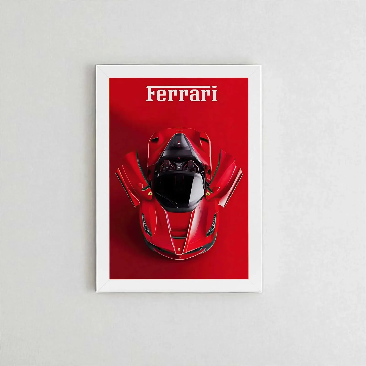 Framed poster of a red Ferrari car on a white wall