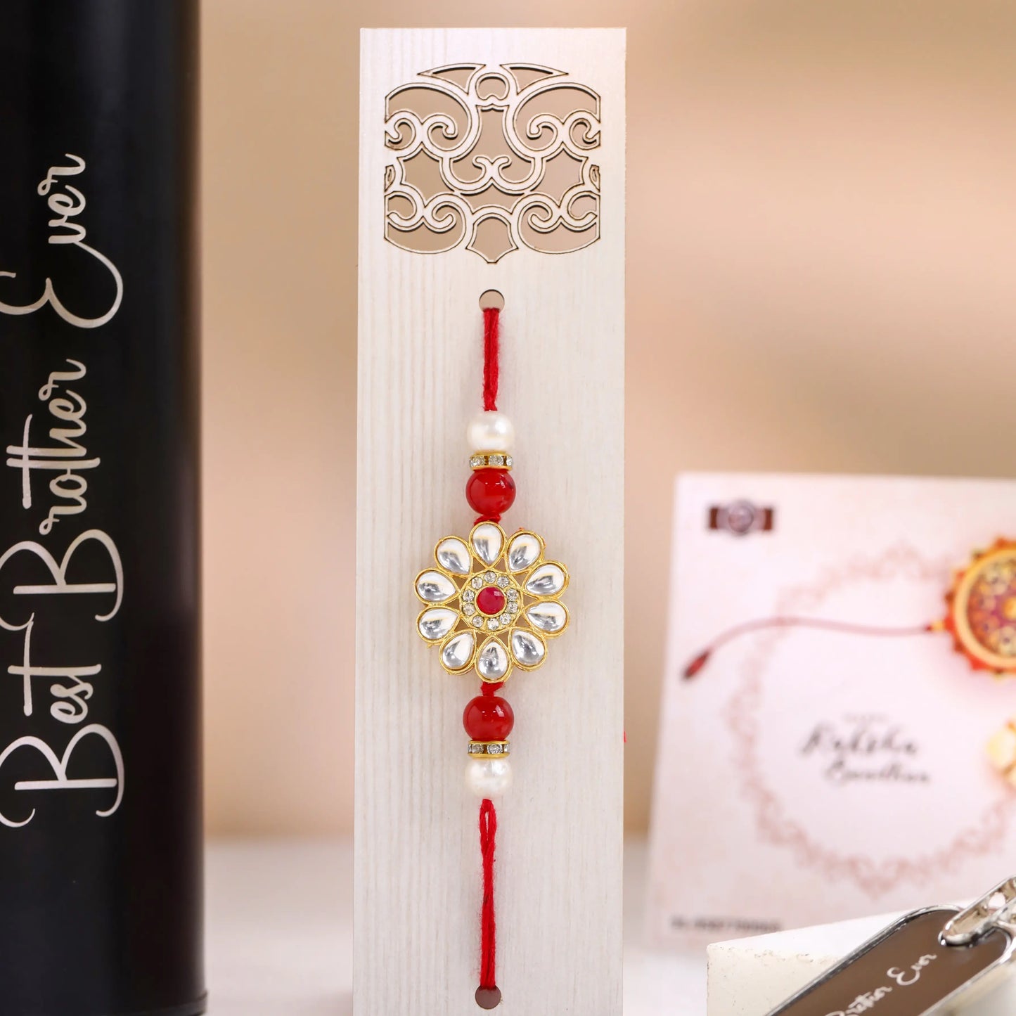lose-up of designer Rakhi with red thread and decorative beads for brother