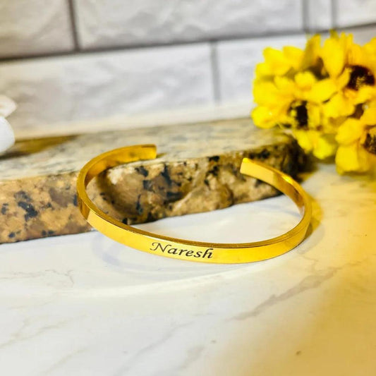 Gold-plated personalized kada bracelet engraved with name "Naresh"