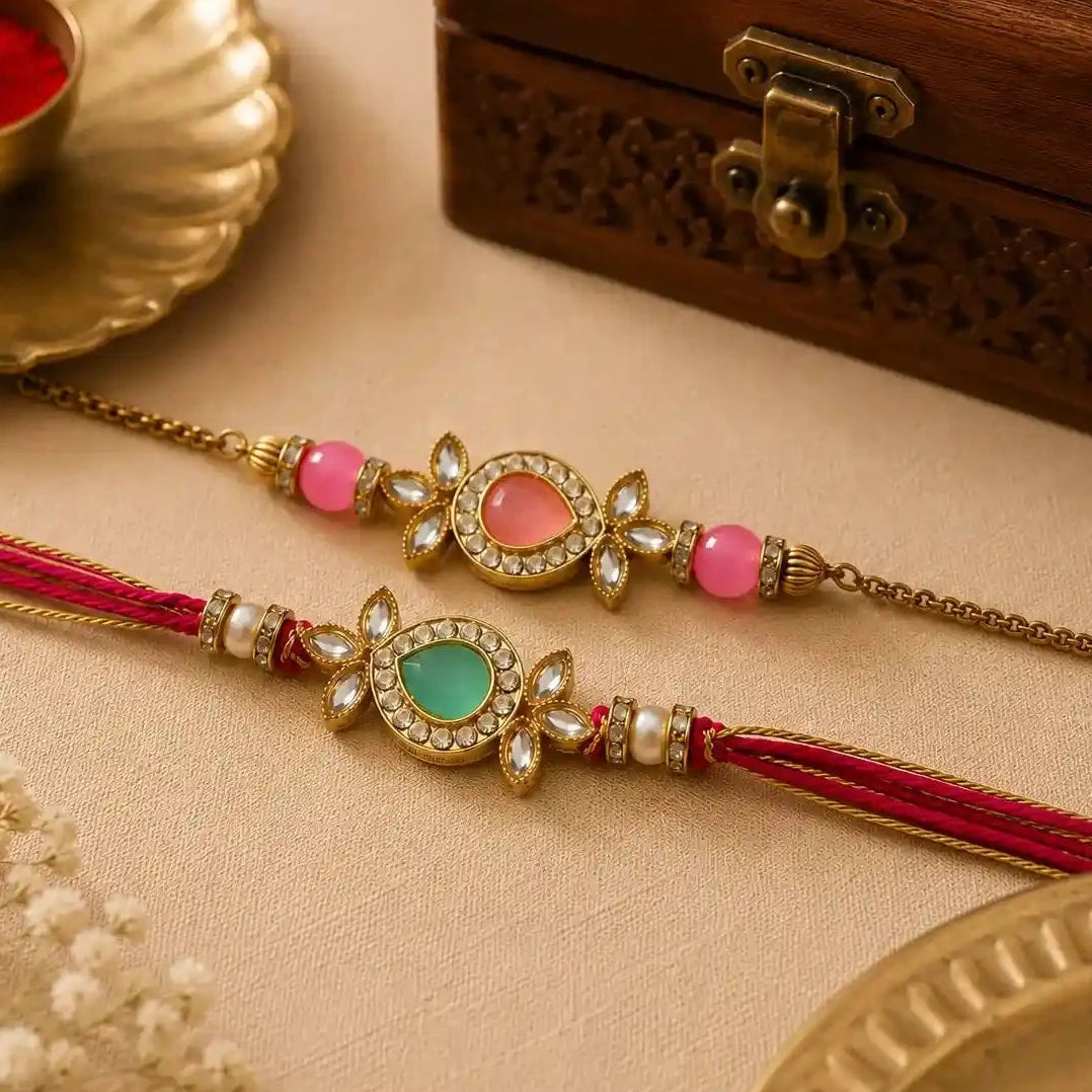 Two decorative bracelets with beads and tassels on a beige surface with a wooden box and small bowl in the background.