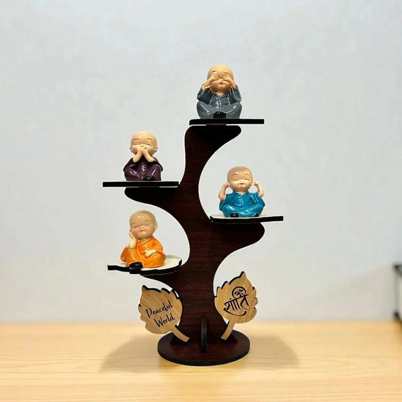 Wooden figurine display stand with small Buddha statues on a wooden surface.