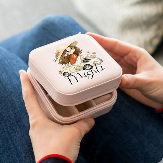 Pink jewelry box with a cartoon design and 'Mishli' text held by hands on a blue fabric background.