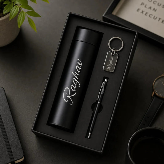 Customized corporate gift hamper featuring a personalized black vacuum flask, pen, and keychain with the name Priya.