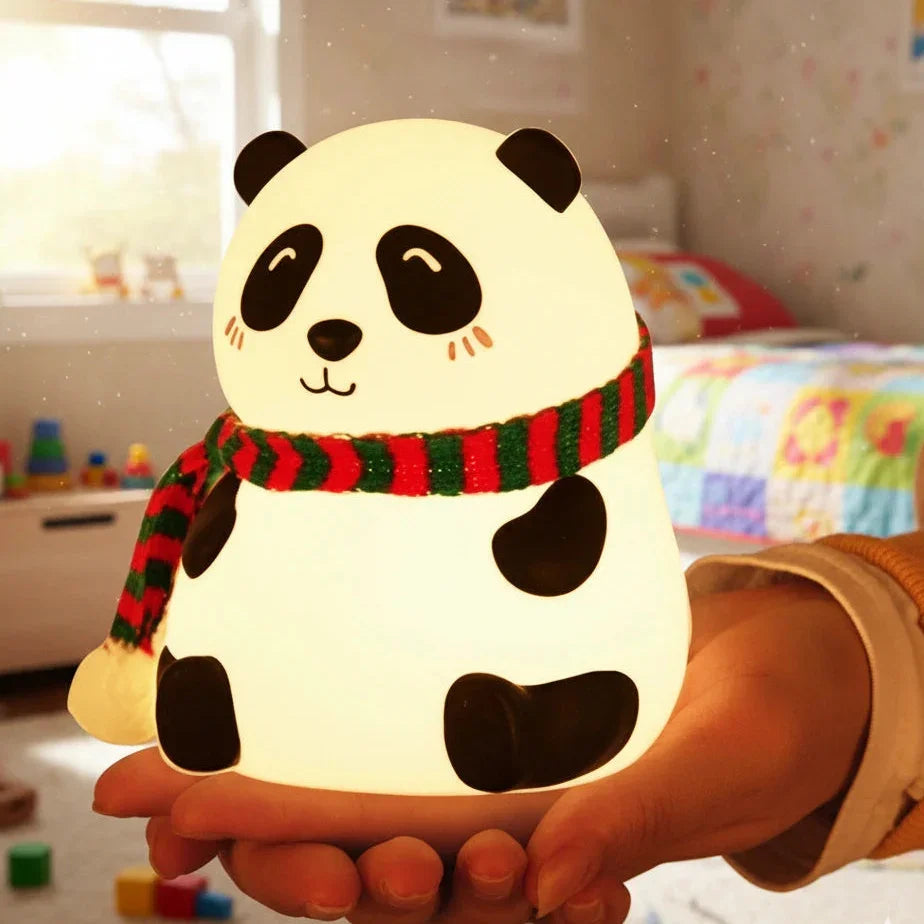 Panda-shaped night light held by a hand in a room with toys on the floor