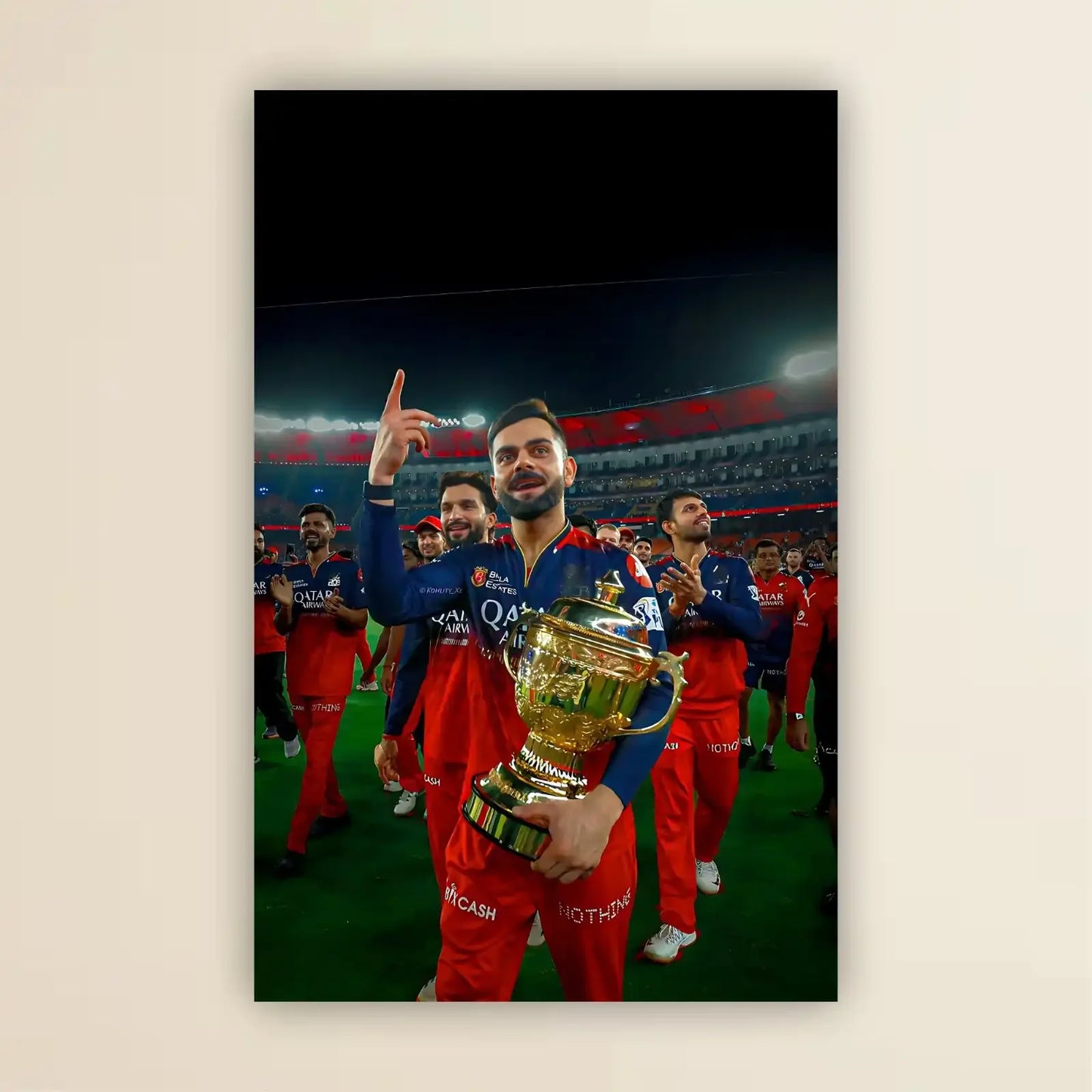 Cricketer holding a trophy with teammates in the background on a sports field