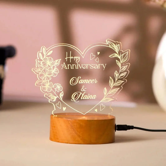 Decorative lamp with 'Happy Anniversary Sameer & Naina' text on a wooden base.