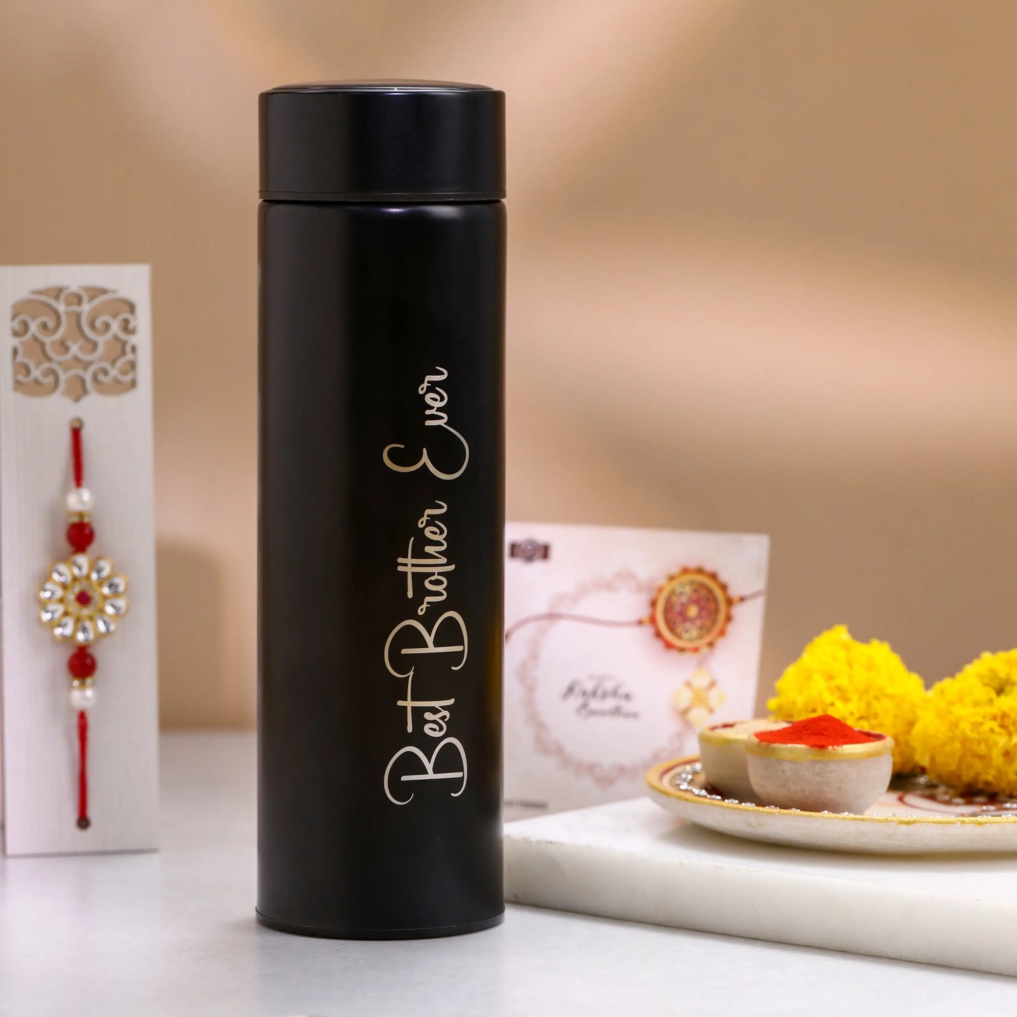 Complete Rakhi hamper with greeting card, bottle, Rakhi, and keychain